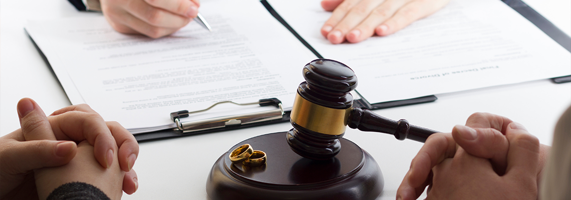 Hands of wife, husband signing decree of divorce, dissolution, canceling marriage