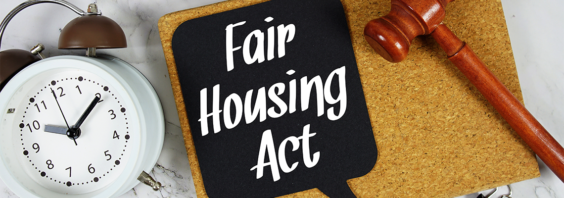 Fair Housing Act text on speech bubble with alarm clock and wooden gavel