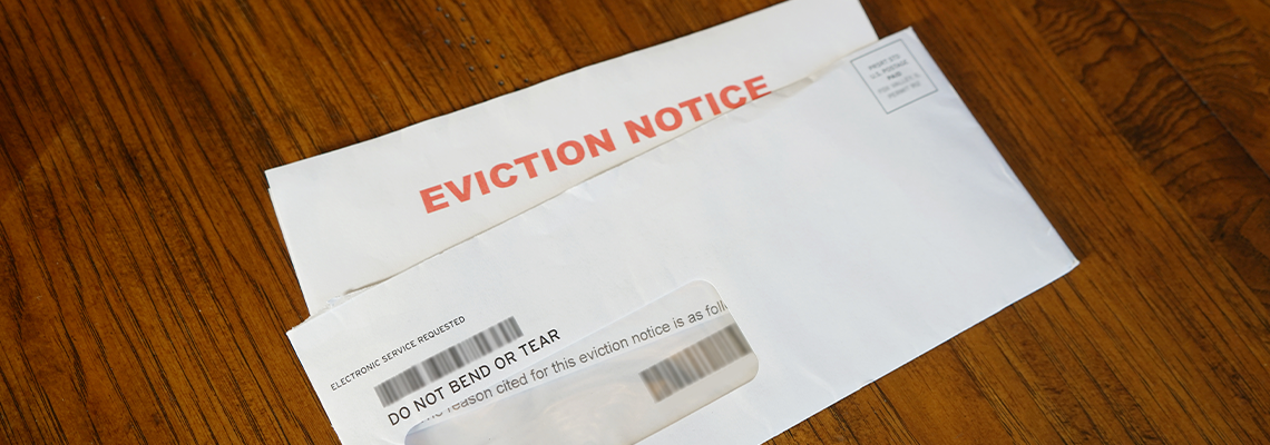 Close-up Of An Eviction Notice In Envelope on Desk