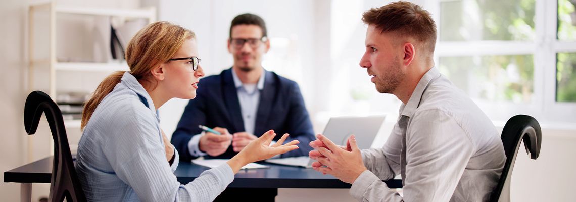 Mediator with young arguing couple