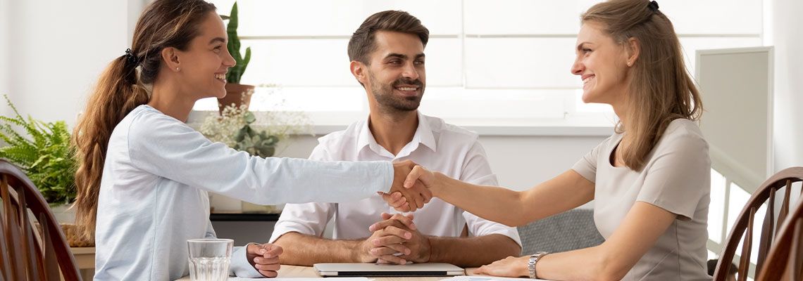 Two parties shaking hands after successful mediation