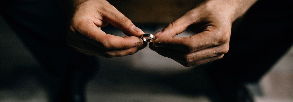 Man holding wedding ring in hand