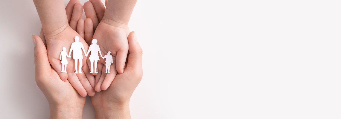 Hands with paper silhouette on table, Parenting Concept
