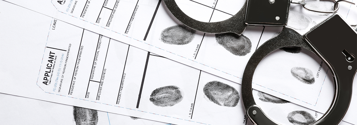 Handcuffs and fingerprint record sheets, top view