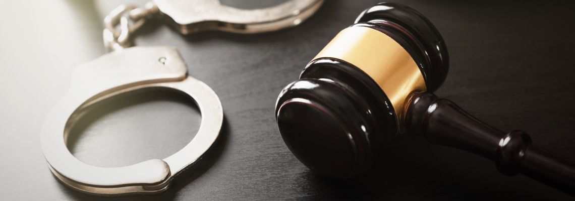 Gavel and handcuffs in table