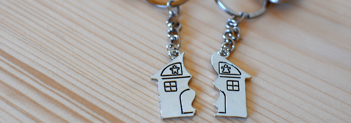 Two keys with splitted or broken key rings with pendant in shape of house