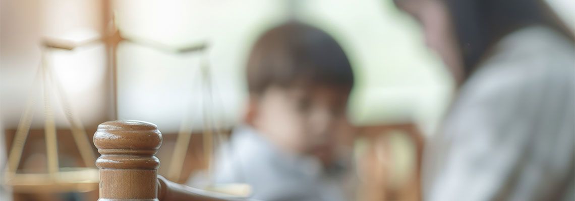 Gavel with mother and child in the background