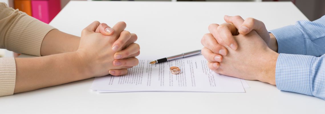 Couples signing divorce paper