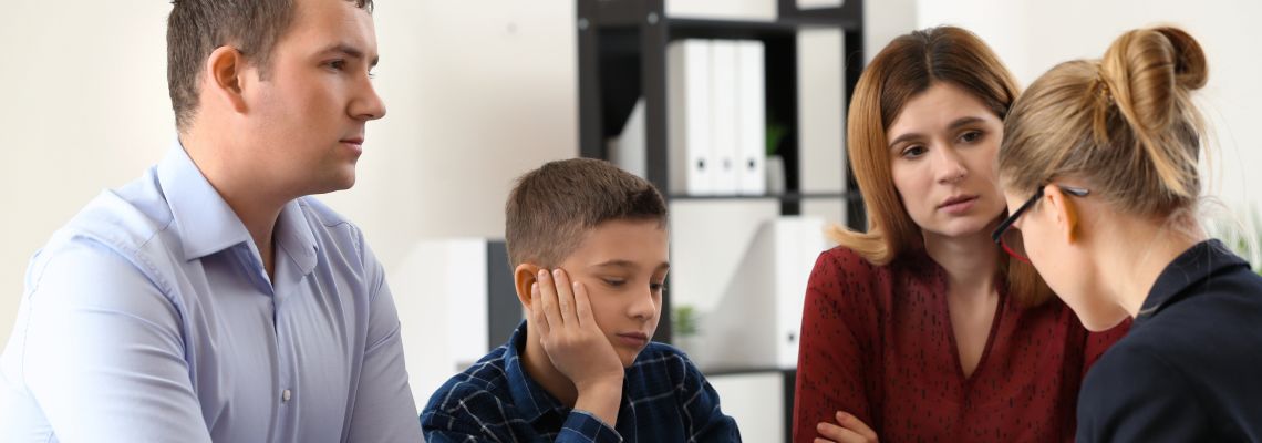 Divorced couple with son consulting attorney to prepare a parenting plan