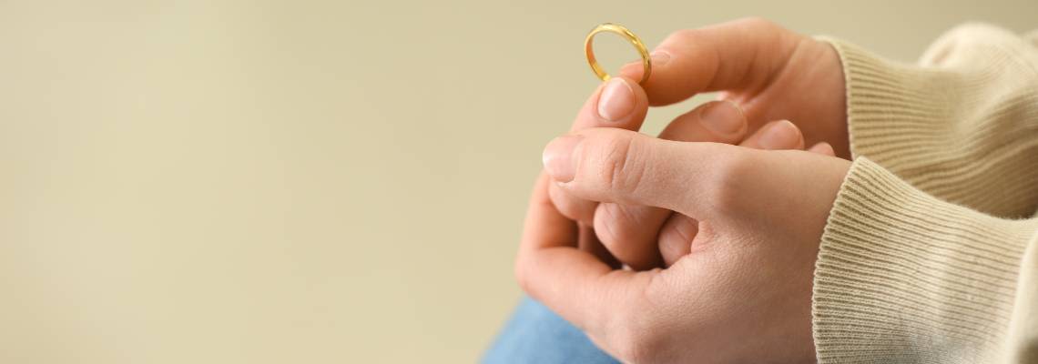 Women holding divorce ring in hand