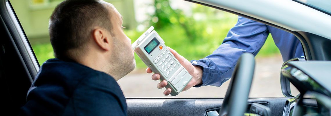 Man blowing into breathalyzer