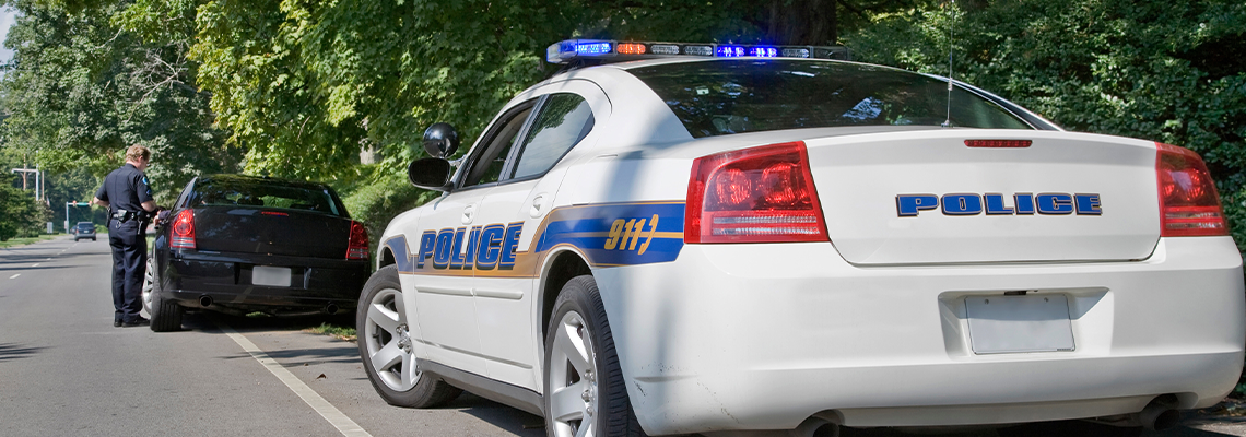 Policeman writing speeding ticket