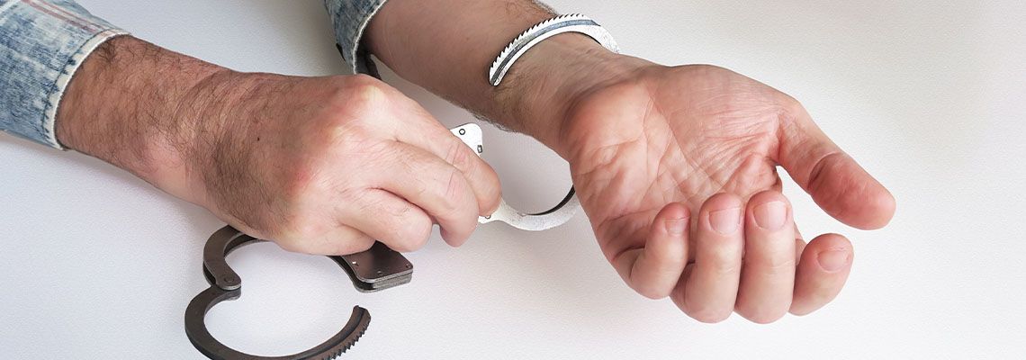 Unbuckling handcuffs from criminal after getting Bail
