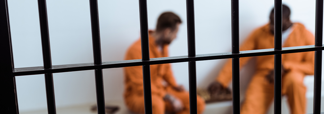 Multicultural Prisoners Playing Chess Behind Prison Bars