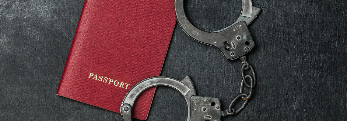 Passport with Handcuffs on Black Background