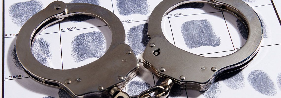 Handcuffs laying on top of fingerprint chart