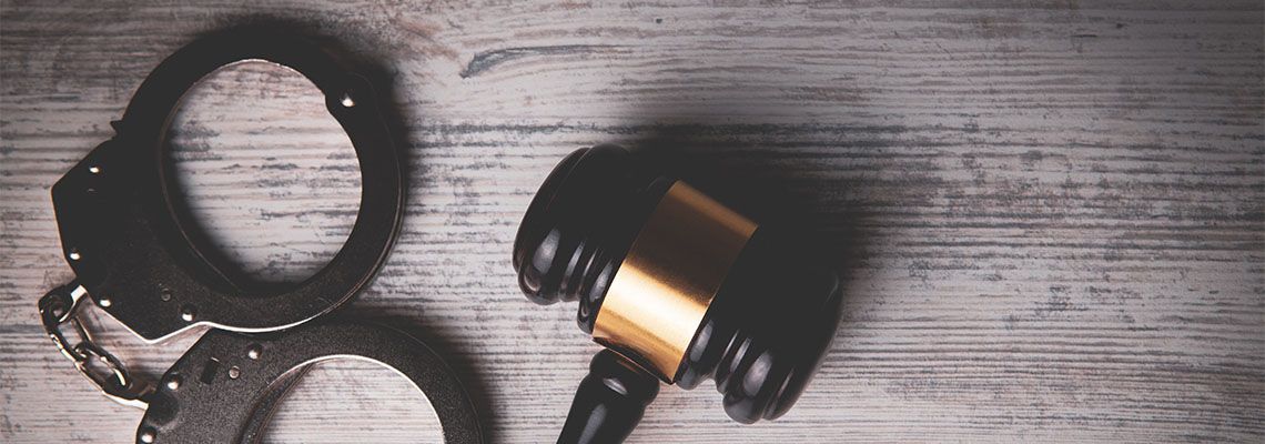 Gavel and handcuff on table