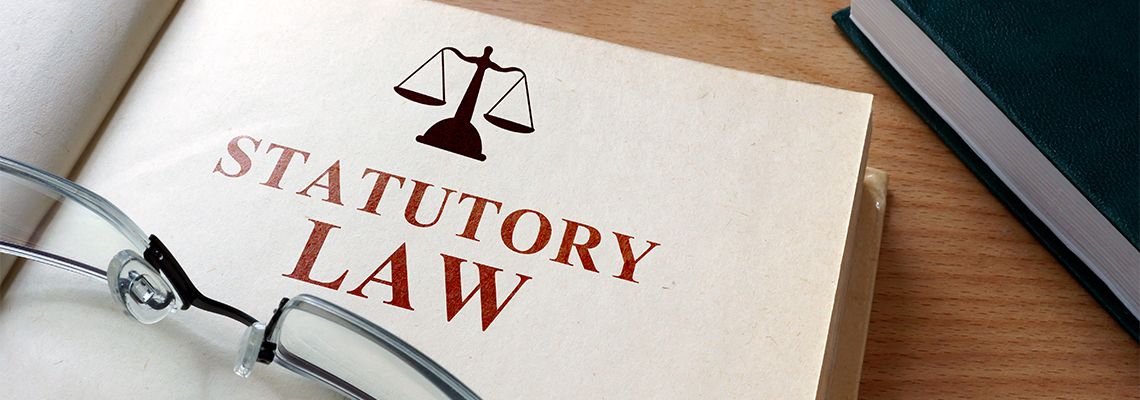 Statutory Law book on a wooden table