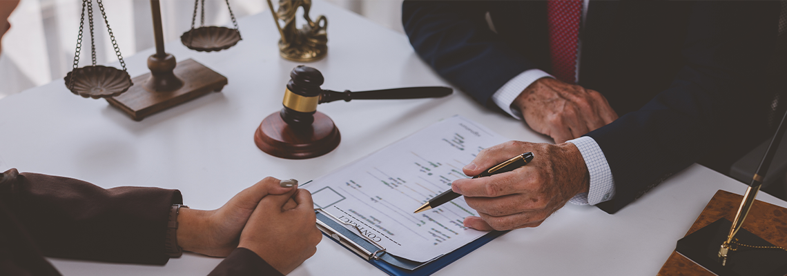 Legal professionals discussing business contract terms in office setting