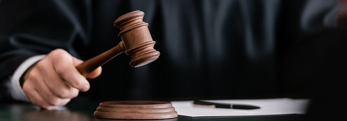 Judge in robe holding gavel in court
