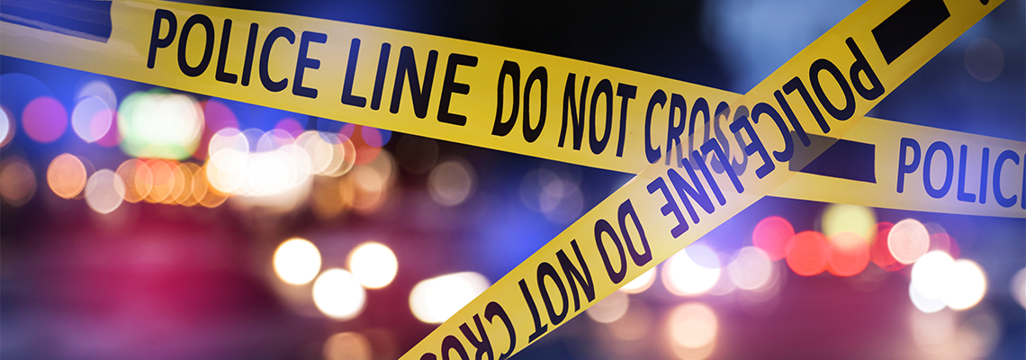 Yellow law enforcement tape isolating crime scene