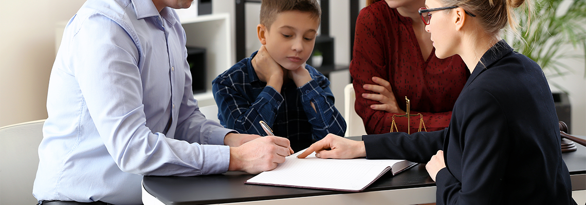Divorced parents with their son visiting lawyer. Concept of child support