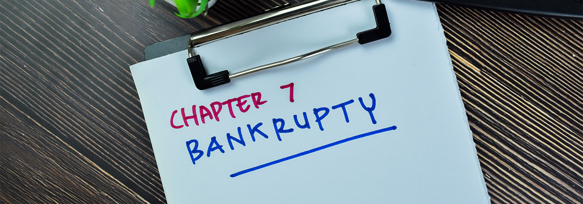 Concept of Chapter 7 Bankrupty write on paperwork isolated on Wooden Table