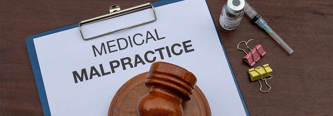 A legal document on medical malpractice is placed in a clipboard