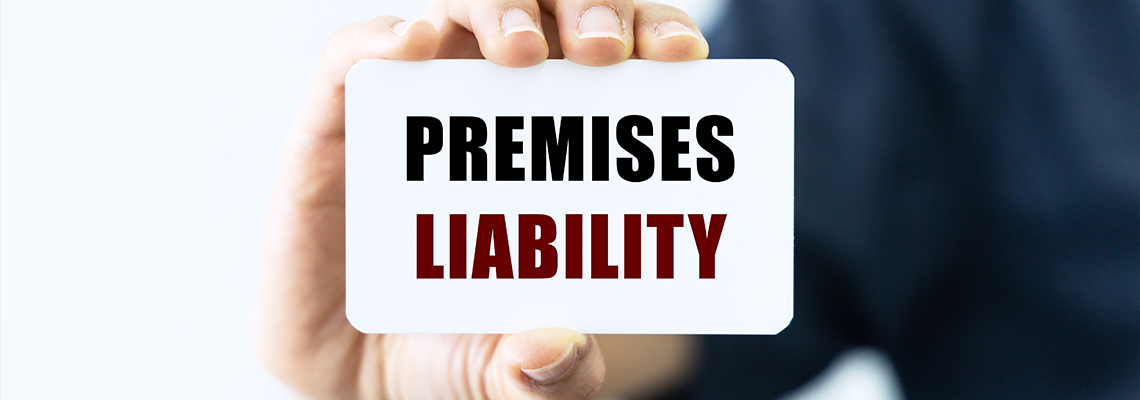 Premises liability text on blank business card being held by a woman's hand