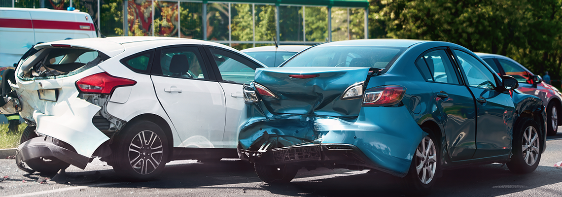 Traffic collision scene with damaged cars