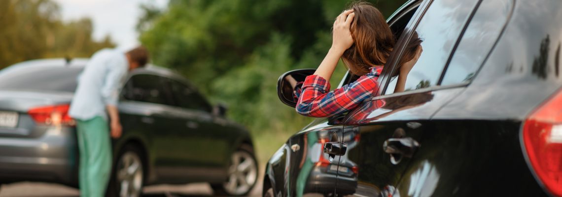 Driver checking for damages after car accident