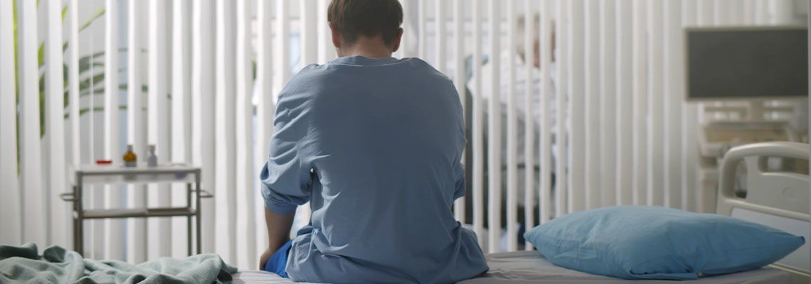 Sad man in hospital bed