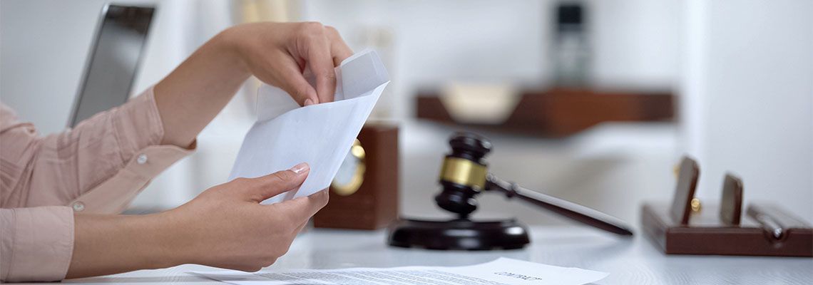Divorced woman holding envelope with alimony