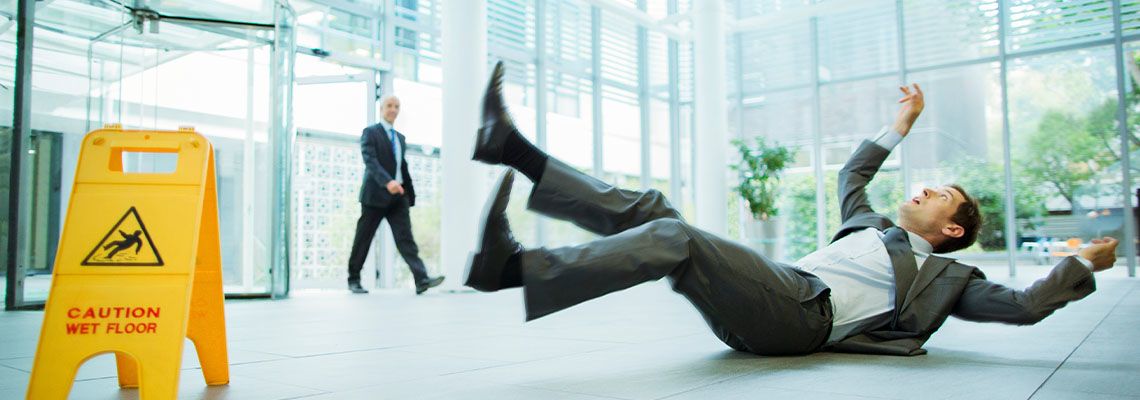 Man slips and falls on wet floor