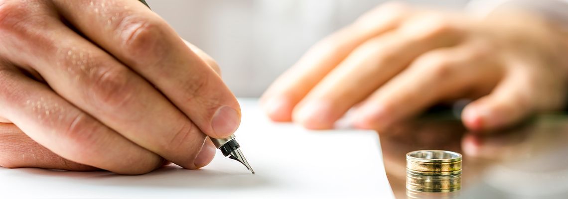 Man signing divorce papers
