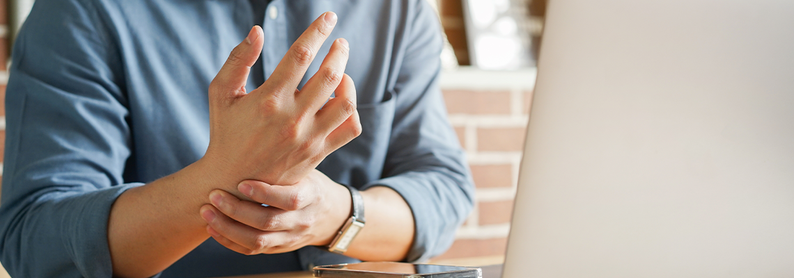 Employee man massage on his hand and arm for relief pain