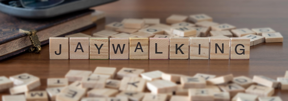 Jaywalking word or concept represented by wooden letter tiles