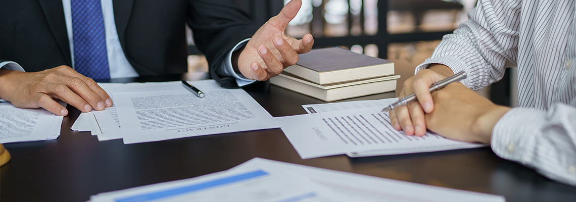Lawyer Legal counsel presents to the client a signed contract with gavel