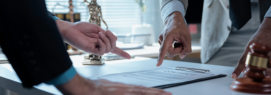 Legal professionals examining contract provisions