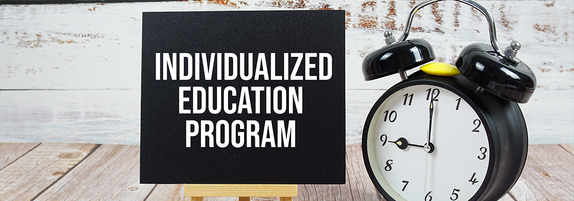 Individualized Education Program text with easel and alarm clock