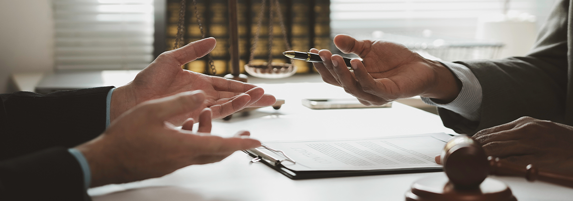 Lawyers discussing legal issues and signing important documents in a courtroom