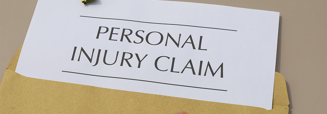 Legal Compensation: Personal Injury Claim and Money on Wooden Desk