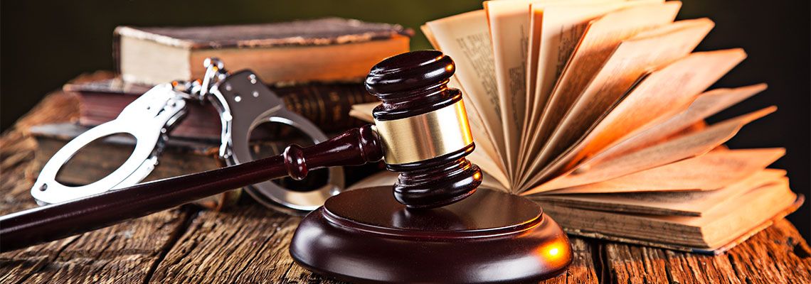 Handcuff, Book and Gavel on table