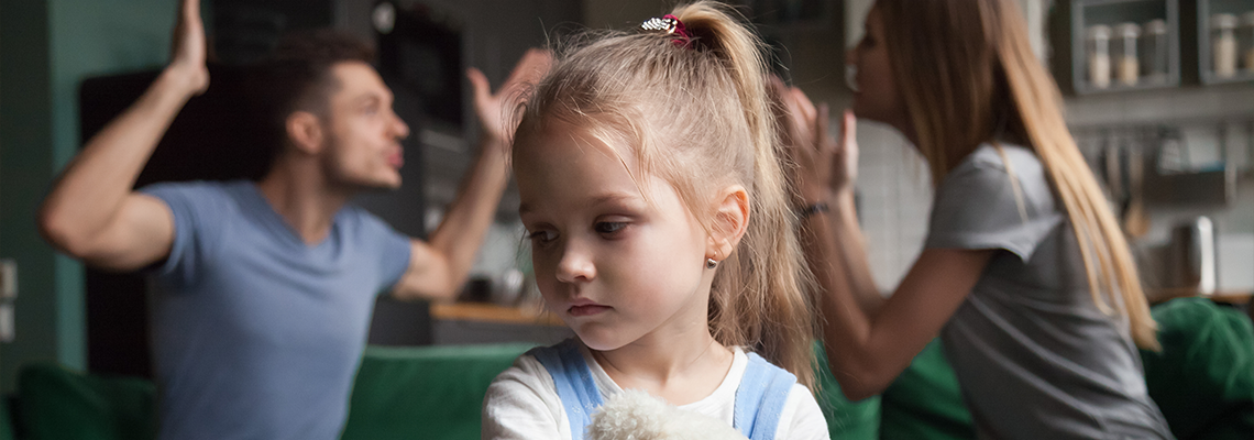 Kid daughter feels upset while parents fighting at background