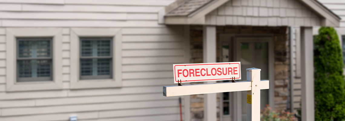 Mockup of a foreclosure sign in front of a modern townhome or townhouse