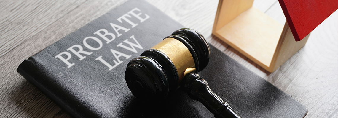Toy house, gavel and text PROBATE LAW on table