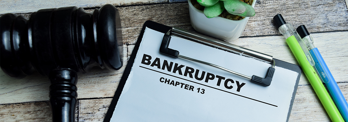Concept of Bankruptcy Chapter 13 write on paperwork isolated on wooden background