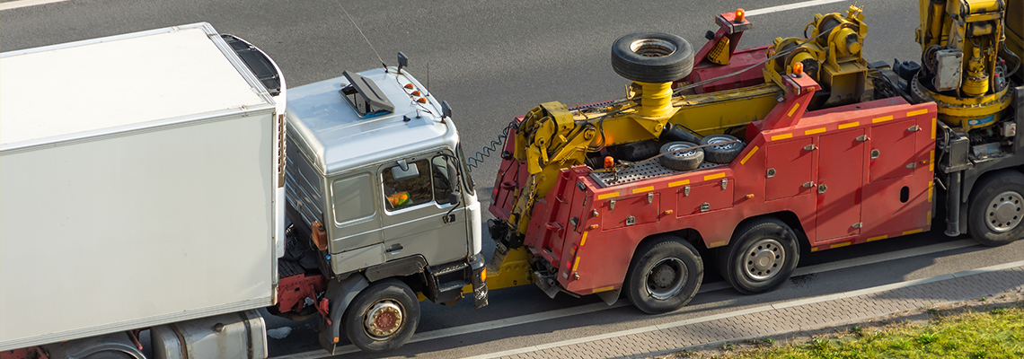 Powerful heavy duty big rig mobile tow semi truck with emergency lights and towing equipment