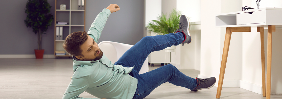 Full body photo of a young clumsy brunette man with unshaven bristles falling