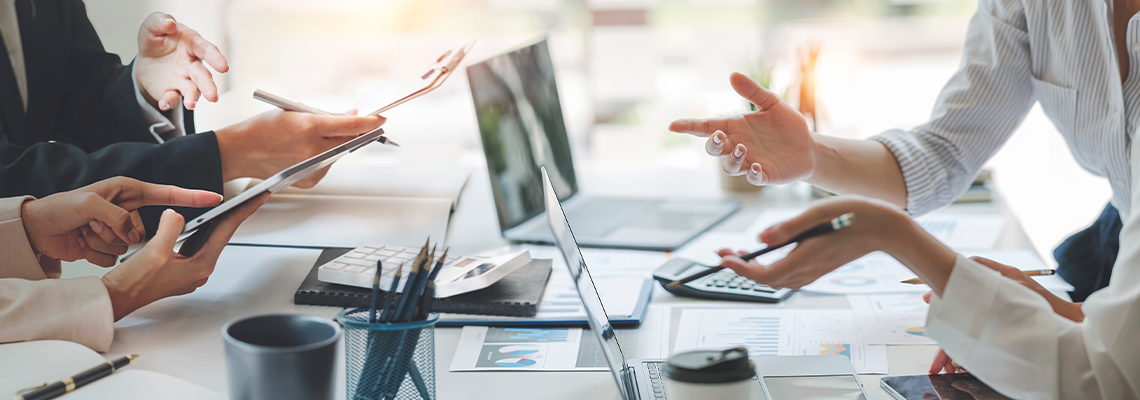 Diverse coworkers working together in boardroom, brainstorming